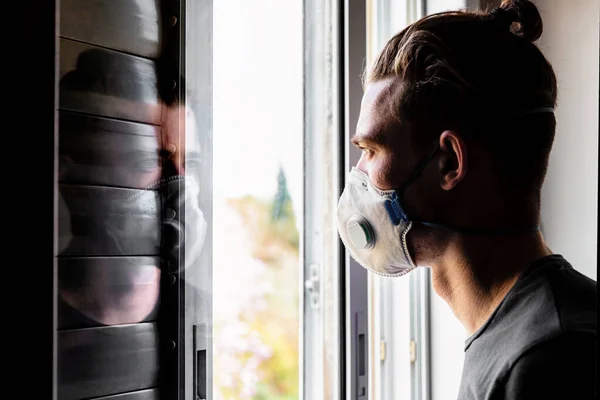 Young Man Medical Mask Looks Out Window Reflected Glass Quarantine — Stock Photo, Image