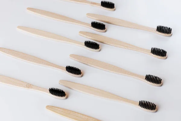 Group Black Eco Bamboo Toothbrushes White Background Top View Pattern — Stock Photo, Image