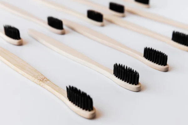 Group Black Eco Bamboo Toothbrushes White Background Top View Pattern — Stock Photo, Image