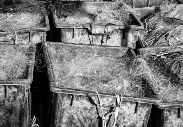 Plastic crates filled with fishing nets. (black and white) — Stock Photo, Image