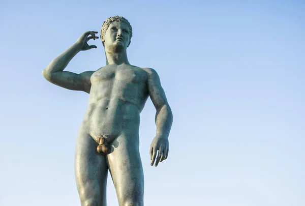 Junge Adonis Bronzestatue mit blauem Himmel Hintergrund — Stockfoto
