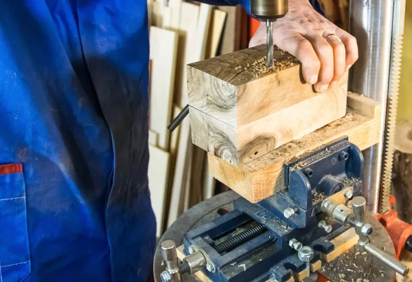 Carpenter workplace- Man using a drill press on wood. — Stock Photo, Image