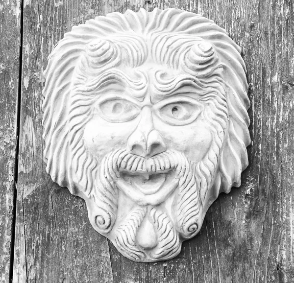 Earthenware Mask on wooden wall.