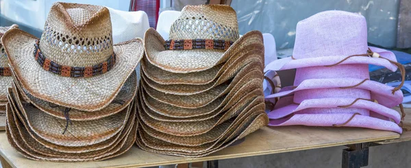 Rack of straw cowboy hats on sale