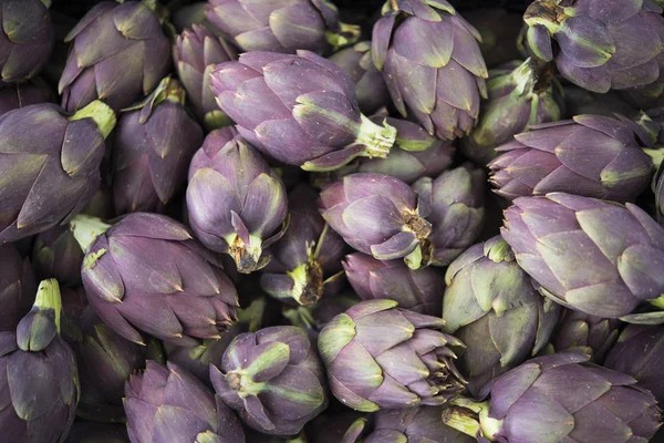 Food background. Green and purple Italian Artichokes