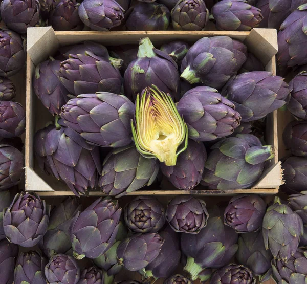 Food background. Green and purple Italian Artichokes
