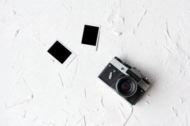 Fotoğraflar ve beyaz masa üzerinde eski fotoğraf makinesi yığını