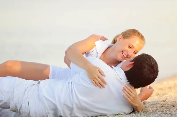Młoda para na plaży w białe szaty — Zdjęcie stockowe