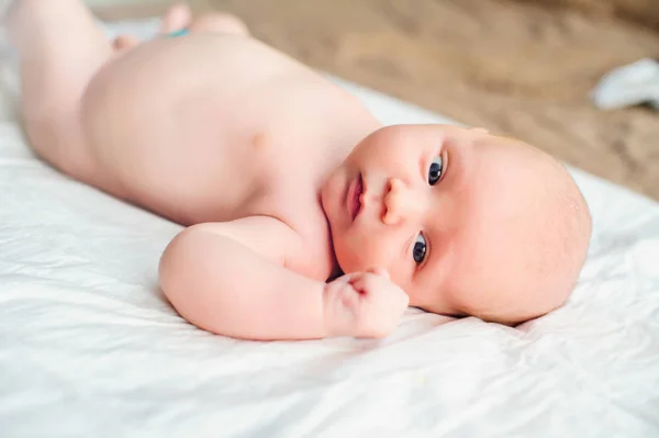 Infant liggande på sängen — Stockfoto