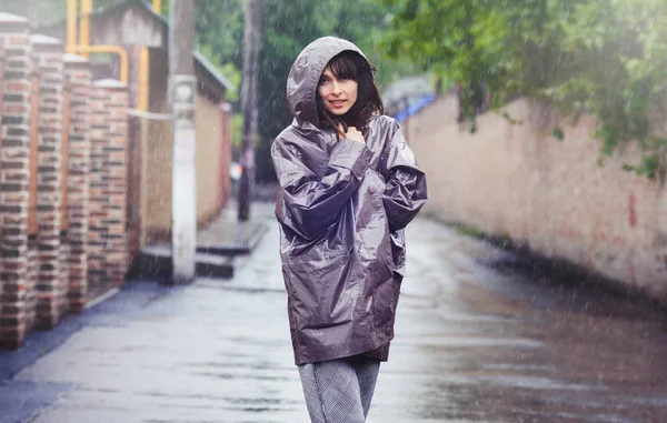 happy woman walking in the rain