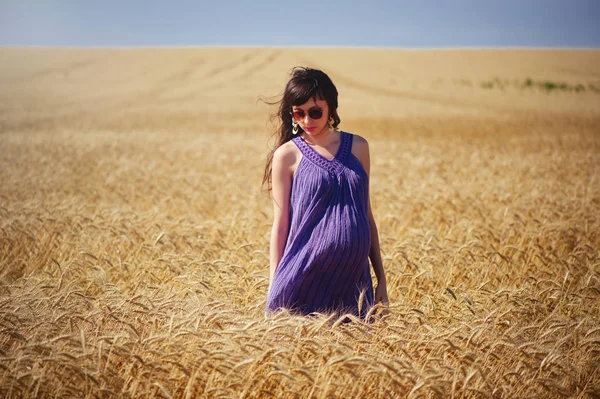 Беременная женщина на пшеничном поле — стоковое фото