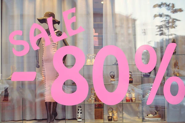 Shop window with women's clothing sale 80%