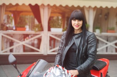 Özgürlük ve stil. Renkli kırmızı Motosiklet ile genç bir kadın portresi. 