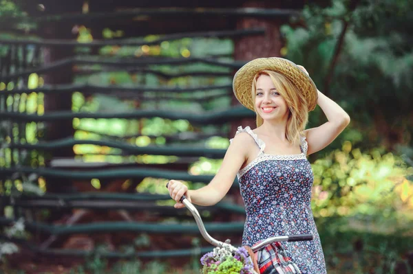 A healthy woman. Beauty Summer model girl with bright colors bicycle forest and basket. style leisure. — Stock Photo, Image
