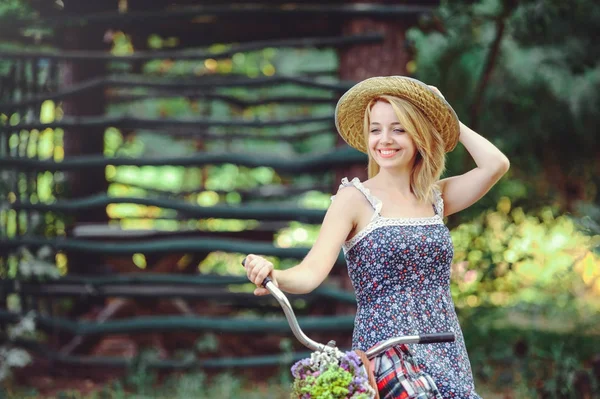 A healthy woman. Beauty Summer model girl with bright colors bicycle forest and basket. style leisure. A beautiful lady raised her hand. Cute face. place for banner and advertisement — Stock Photo, Image