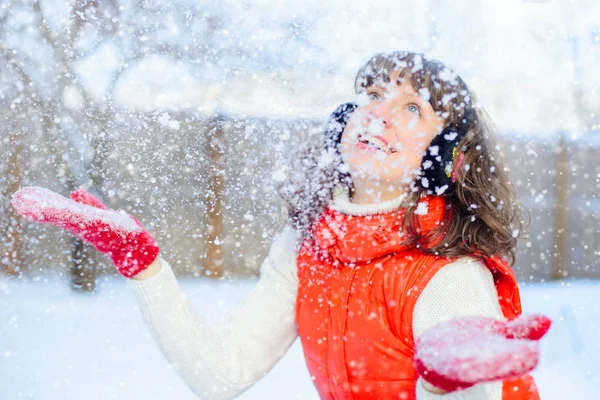 Genç güzel mutlu gülümseyen kız eldiveni, açık parlak fotoğraf dışında. şık parlak kış elbiseleri giyin, kar düşüyor. Çek. Noel, yeni yıl, kavram. Büyülü kar yağışı — Stok fotoğraf