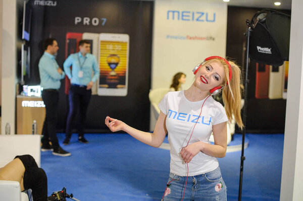 Meizu girl in headphones dancing at the exhibition Ukrainian Fashion Week