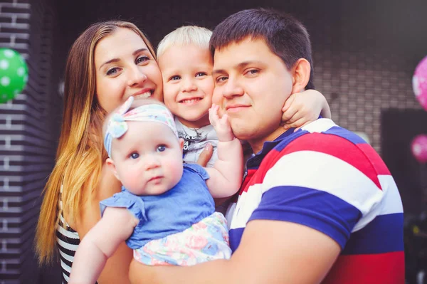 Heureuse jeune famille avec enfants, parents et enfants sur le fond de leur propre maison, maison familiale — Photo