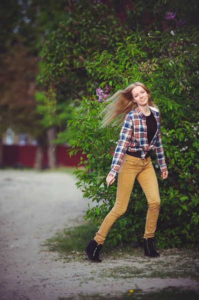 Hermosa mujer rubia en un camino rústico es feliz, sobre un fondo de muchos árboles verdes, un hermoso retrato de estilo rústico, una imagen casera simple —  Fotos de Stock