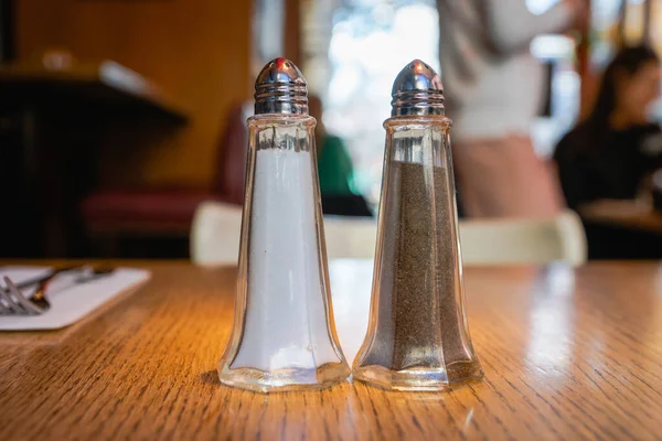 salt and pepper - pepper shaker and salt shaker, the most popular seasonings, black pepper and salt on the table in restaurant