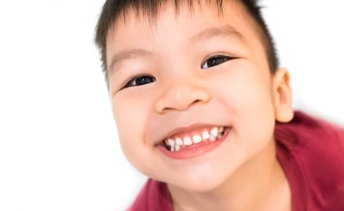 Asyalı çocuk beyaz arka plan beyaz sağlıklı dişlere sahip gülümseyen