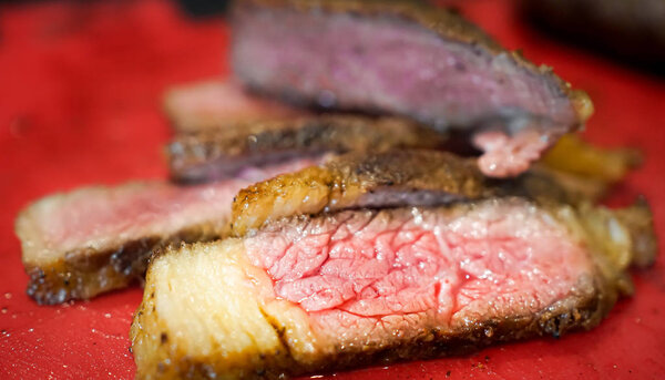 Pink Medium rare beef steak cut in to pieces