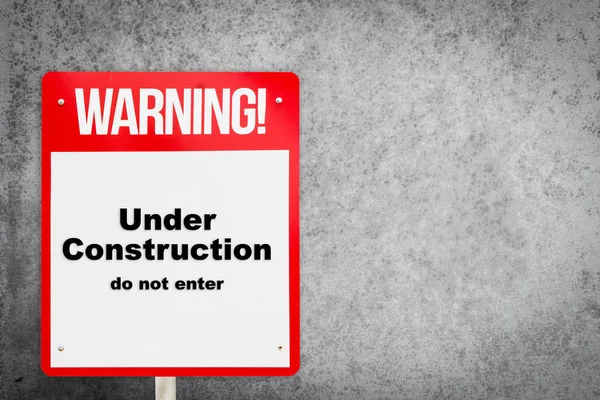 Under construction warning signage with copy space. — Stock Photo, Image