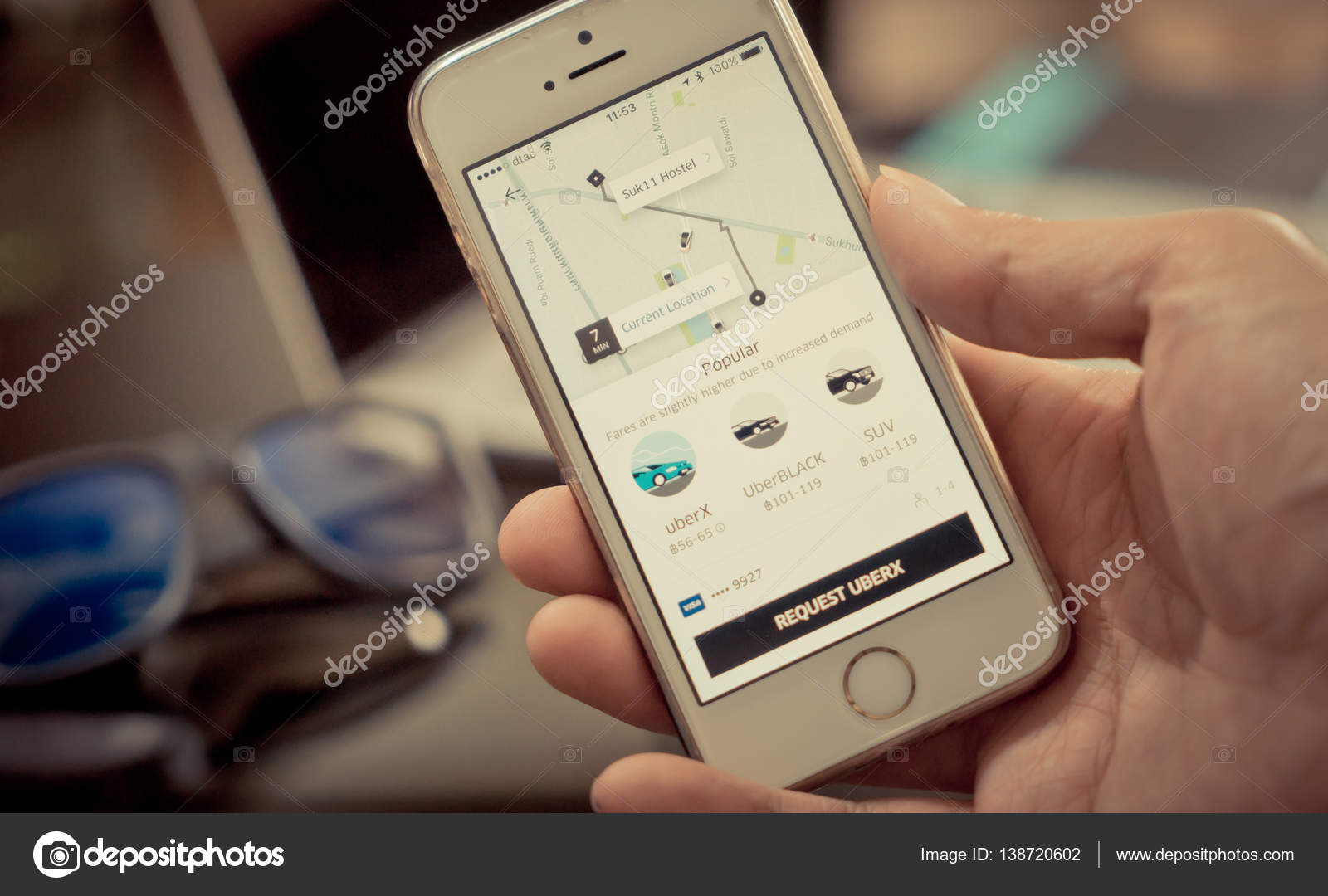 Business man is using Uber application on his iPhone. u2013 Stock 