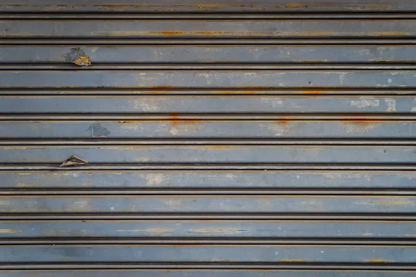 Gray Rustic store retail metal gate wall closed.