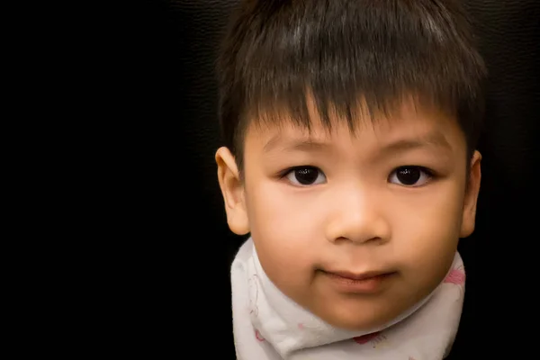 Liitle asian boy is smiling in low key tone — Stock Photo, Image