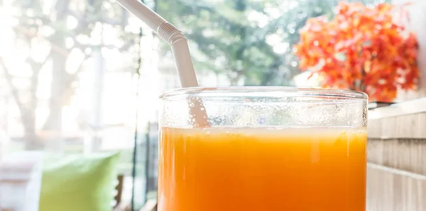 A glass of orange fresh juice on cafe table — Stock Photo, Image