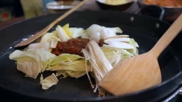 Приготовление барбекю корейская свинина с лапшой на горячей сковороде — стоковое видео