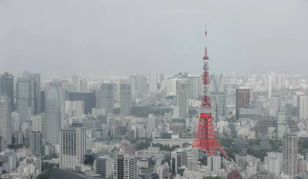 Red Tokyo Tower surrounded by commercial building. — Stock Photo, Image