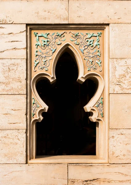 Arabian style window on brown brick wall