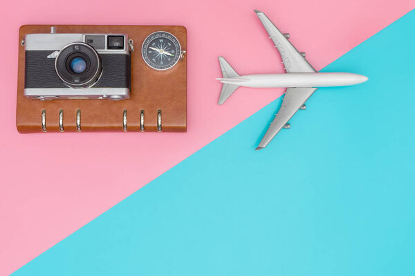 Travel blogger objects on pink and blue copy space