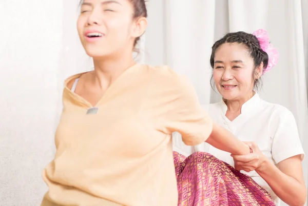Thai Massage Therapist is hurting a women by stretching her back — Stock Photo, Image