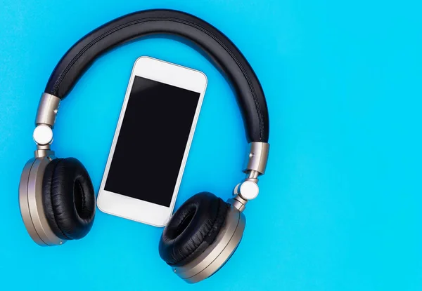 Blank Mobile phone screen inside of Golden headphone — Stock Photo, Image