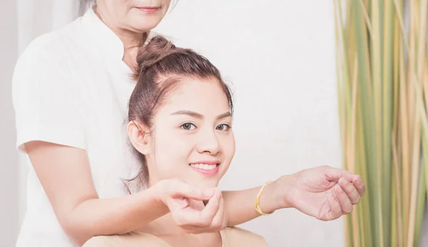 Asiático las mujeres es llegar tailandés masaje en su hombro — Foto de Stock