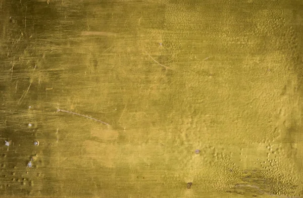 Grungy ผนังทาสีในพื้นผิวสีทอง — ภาพถ่ายสต็อก
