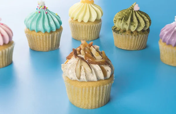Caramel and nut mini cupcake with colorful cupcake on the background