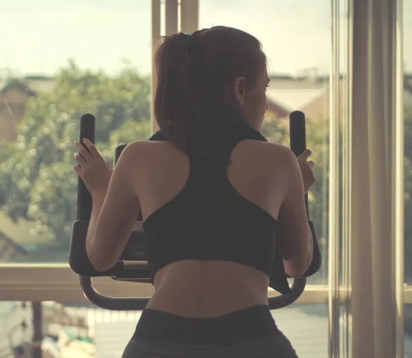 Woman Running Treadmill Facing Out Windows — Stock Photo, Image