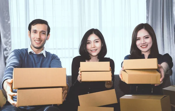 Three start up business partner is holding delivery boxes ready to send out to customer