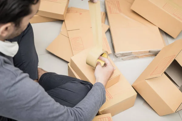 online business owner Packing boxes to send to customer