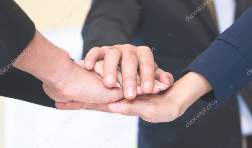 Four hand together in business meeting for team concept