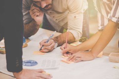 Genç İşletme Ekibi iş için çizelge ve dosya üzerinde çalışıyor.