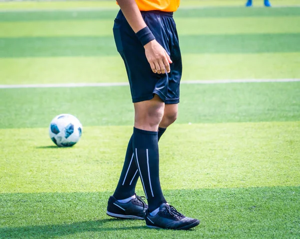 Soccer football referee leg and foot on a soccer competition fie — Stock Photo, Image