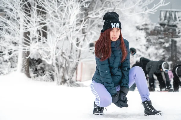 beauty atractive woman with winter fashion clothing with beautiful skin face in snow skii resort, closed up portrait.