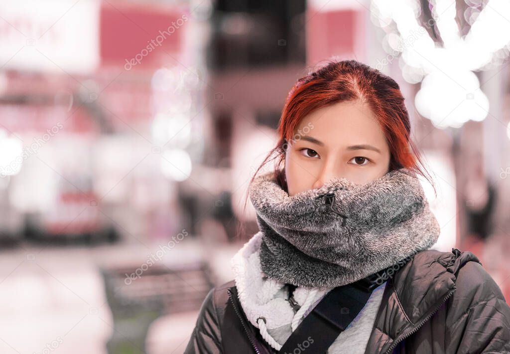 Portrait of Red hair Asian woman is walking in busy street of Sendai Japan for beauty and winter fashion concept.