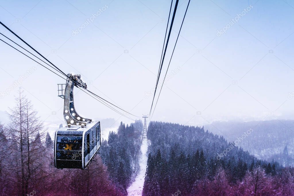 Cable car is traveling on ropeway through a beautiful woodland landscape in Zao Skii resort