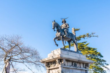 Sendai; Japan - 29 Dec 2019: Date Masamune monument riding on a horse located in Ruin of the old Sendai Aoba castle. clipart
